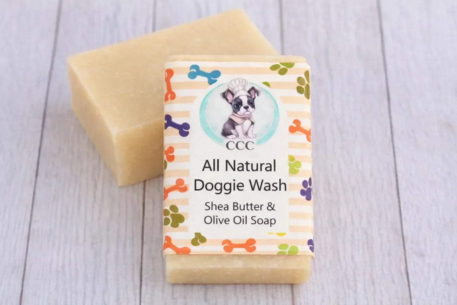 All natural dog wash soap bar with shea butter and olive oil for pets on wood surface